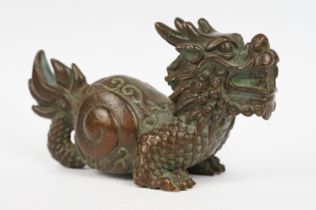 An ornamental chinese bronze dragon figure.