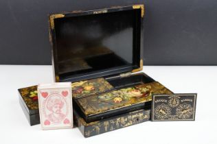 19th century black lacquered games box, the lid painted with exotic birds amongst flowers, with