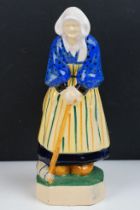 Henriot Quimper figure of an elderly lady, circa 1930's, with polychrome decoration, designed by