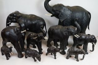Group of nine Liberty style leather bound elephants with glass eyes, of varying size (tallest approx