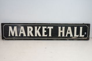 ' Market Hall ' large painted wooden rectangular wall sign, with white lettering on black ground.