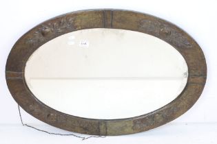 Arts and Crafts Copper Framed Oval Mirror with relief decoration and bevelled edge, 87cm x 60cm