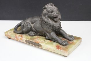 'Souvenir de Belfort' spelter figure of a recumbent lion, raised on a rectangular onyx base, 22cm