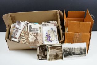 A collection of mainly early 20th century postcards to include printed and real photo examples.