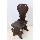 19th century Oak Hall Chair with shaped plain back and solid seat and two shaped panel supports,