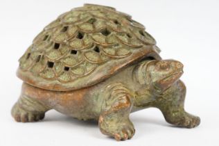 An oriental cast metal incense burner in the form of a tortoise.