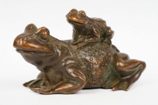 An ornamental Chinese copper figure of a toad carrying a smalller toad.