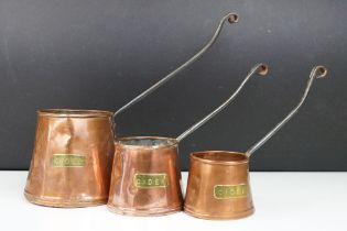 Set of Three 19th century Graduating Copper Cider Measures with iron handles, largest 27cm high