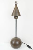 Modernist style table lamp having an orb shaped base with column, orb and conical termination.