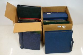 A collection of empty stamp albums and stock books contained within two boxes.