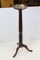 19th century Mahogany Torchere, the circular top raised on a reeded and twisted column and three