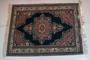 Dark Blue and Pink Ground Rug decorated with flowers and geometric patterns within a cream ground