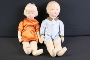 Pair of mid 20th C cloth covered dolls, clothed, with painted facial features and sewn hair.