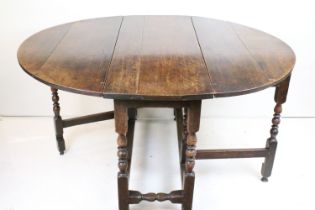 Antique Oak Oval Gate-leg Table raised on turned and block supports, 73cnm high x 116cm long