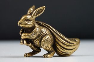 An ornamental chinese bronze lucky fortune rabbit with bag.