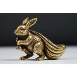 An ornamental chinese bronze lucky fortune rabbit with bag.