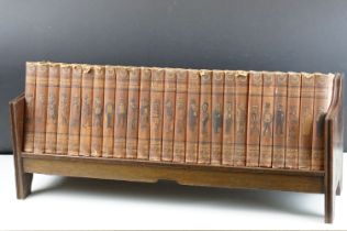 Set of 25 ' Punch Library of Humour ' books, housed on a wooden book trough, approx 64cm wide