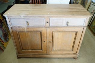 Early 20th century Limed Oak Side Cabinet with two drawers over two cupboard doors, raised on