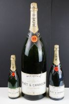 Large Moet & Chandon champagne dummy bottle together with two smaller examples. Measures 68cm