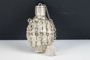 An Oriental white metal filigree bottle with figural decoration.