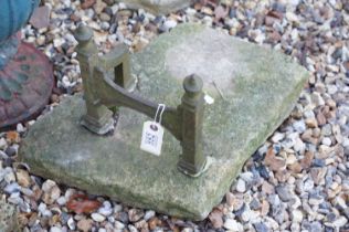 Cast iron boot scraper set into a stone base