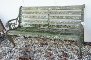 Wooden slatted garden bench, the cast iron ends with lion mask features, approx 125cm wide