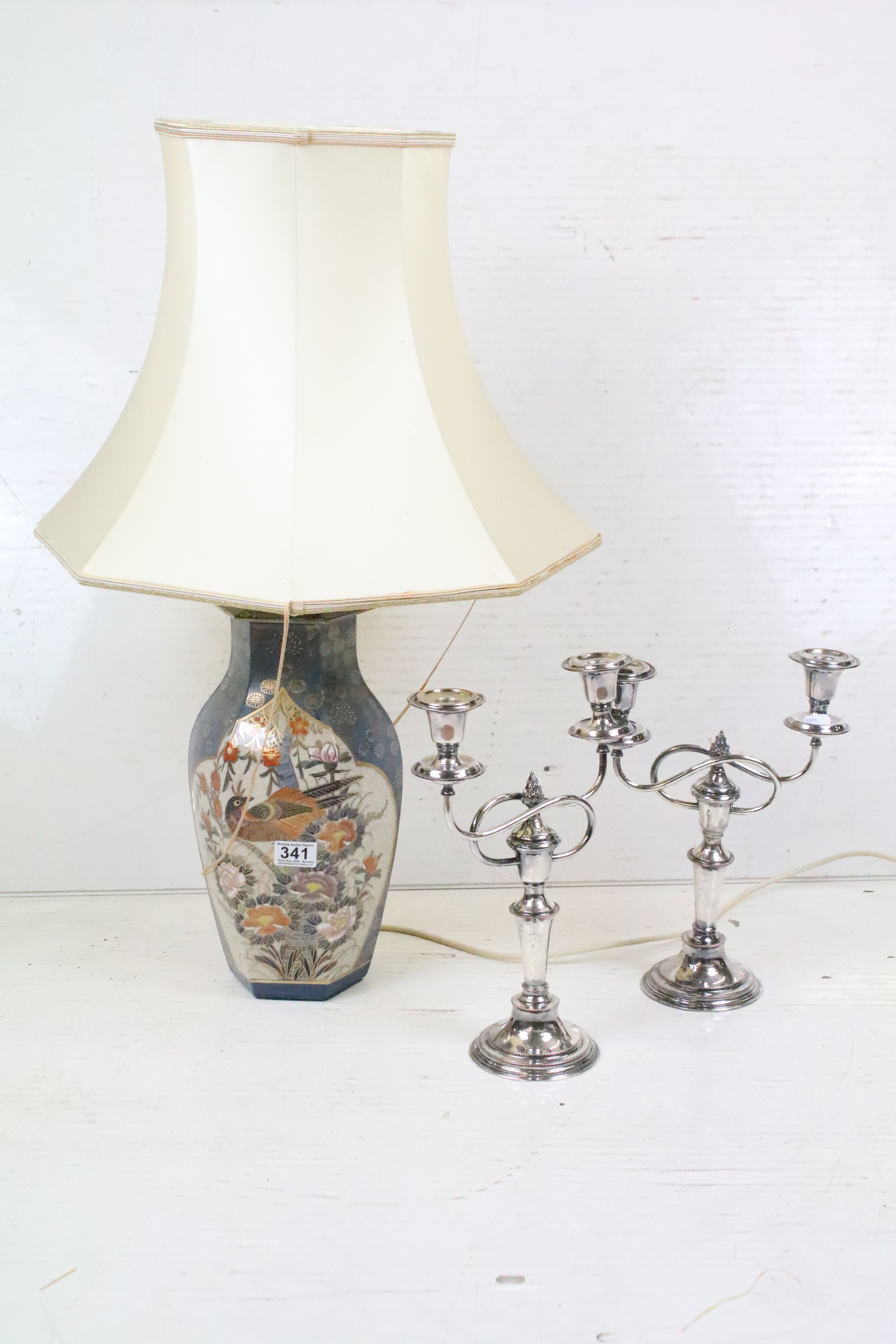 A ceramic oriental style table lamp together with two silver plated candlesticks.