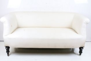 Late 19th / Early 20th century Chesterfield style Sofa covered in plain calico fabric, raised on