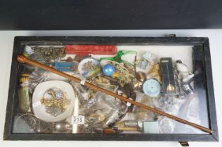 A group of mixed collectables contained within a glass topped display case to include jewellery,