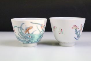 Pair of Chinese porcelain tea bowls with enamel floral & insect decoration, six-character marks to