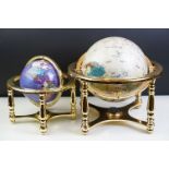 Two gemstone globes on brass stands, with built-in compasses to base, tallest approx 31cm high