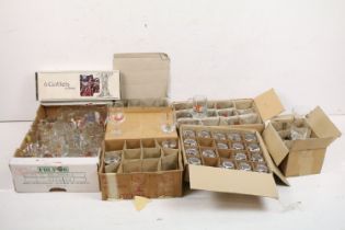 A large collection of drinking glasses to include advertising examples contained within seven boxes.