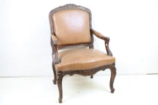 French Carved Walnut Open Armchair with brown leather upholstered back, seat and elbow pads. 95cm