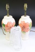 Pair of Moorcroft Hibiscus pattern table lamps, of baluster form, cream ground, approx 38cm tall (
