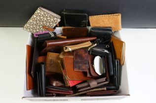 A collection of mainly leather vintage wallets and purses.