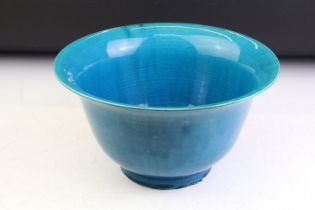 Chinese blue glazed flared rim bowl raised on footed base. Unmarked. Measures 27.5cm diameter.