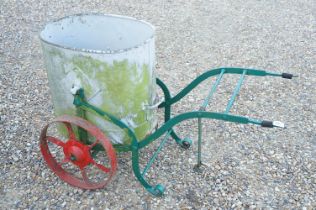 Wrought iron trolley on cast iron wheels, with steel bucket, measures approx 120cm long
