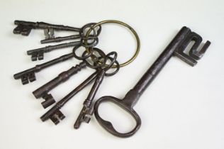 A collection of eight antique cast iron keys.