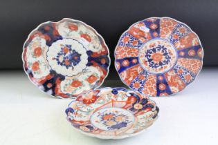 Three 19th Century Japanese Imari plates having blue and white under glazed panelled details and red