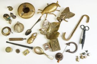 A box of collectable metalware to include brass fireside vestas, ashtray, adverting spoon,