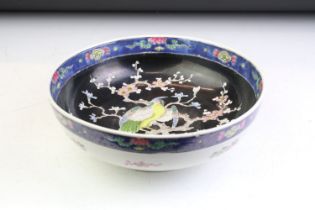 Chinese footed centrepiece bowl having an over glaze enamelled bird perched in a blossom tree to