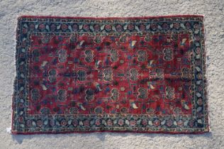 Eastern Wool Maroon ground Rug with stylised pattern within a border, 146cm x 91cm