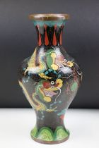 Chinese cloisonne enamelled vase having a back ground with Chinese dragon detailing. Measures 26.5cm