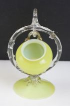 19th Century Victorian vaseline glass ornament having a small vase suspended to the centre raised on