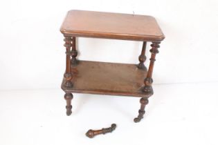 Victorian Walnut Two Tier Table with turned supports terminating in castors (one leg broken), 59cm