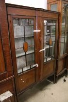 Edwardian Mahogany Inlaid Display Cabinet, the two doors opening to a pale green fabric lined