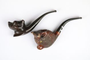 Two novelty wooden smokers pipes with carved bowls in the form of animals.