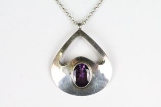 A 925 sterling silver modernist pendant with faceted amethyst centre stone mounted to 925 sterling