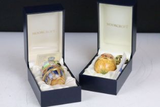 Two Moorcroft enamel egg shaped boxes to include and Rabbit and a Chicken example, both housed