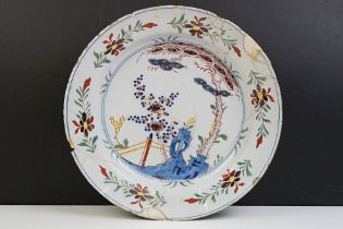 18th Century English Delft plate featuring a hand painted garden scene. A/F, extensively repaired.